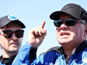 Star Trek actor William Shatner speaks as Planet Labs co-founder Chris Boshuizen looks on during a media availability on the landing pad of Blue Origin’s New Shepard after they flew into space on Oct. 13, 2021 near Van Horn, Texas.