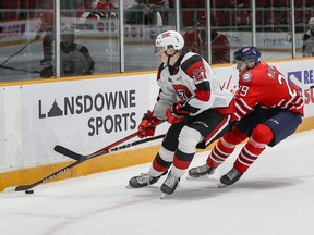 Ottawa 67's defenceman Jack Matier keeps the puck away from Oshawa Generals winger Daniel Michaud during an Ontario Hockey League game yesterday at TD Place in Ottawa. The 67's won 7-3.