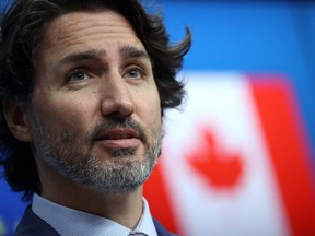 (FILES) In this file photo taken on June 15, 2021 Canadian Prime Minister Justin Trudeau gives a press conference following a meeting with European council president and EU commission president as part of the EU-Canada summit in Brussels. - The minority government of Canadian Prime Minister Justin Trudeau survived a parliamentary vote of no confidence June 23 in a face-off over the proposed budget, eliminating the possibility of early elections this summer. The House of Commons voted 211 to 121 in favor of approving the budget, which was proposed in April and contains a plan to spend CAN$101.4 billion (69 billion euros) over three years. (Photo by KENZO TRIBOUILLARD / AFP)