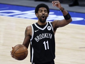 Brooklyn Nets guard Kyrie Irving (11) reacts during the third quarter against the Dallas Mavericks at American Airlines Center.