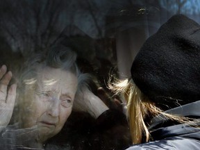 COVID-19-Diane Colangelo visits her 86-year-old mother Patricia through a window at the Orchard Villa long-term care home in Pickering on Wednesday, April 22, 2020. Patricia tested postivive for coronavirus days later and died on May 7, 2020.