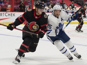 Senators centre Shane Pinto (12) battles with Maple Leafs centre Alexander Kerfoot in the first period of a pre-season game on Oct. 4.