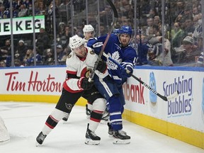 Ottawa Senators forward Chris Tierney (71) and Toronto Maple Leafs forward Alexander Kerfoot (15) battle for position during the second period at Scotiabank Arena, Oct. 16, 2021.
