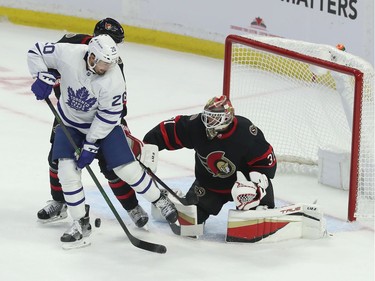 Ottawa Senators taking on the Toronto Maple Leafs during first period action at the Canadian Tire Centre Thursday. Nick Ritchie from the Leafs tries to tip the puck past Senators goalie Anton Forsberg.