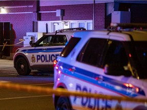 Ottawa Police Service vehicles near 131 Parkdale Ave., where an investigation into a double shooting continues on Wednesday, Oct. 20, 2021.