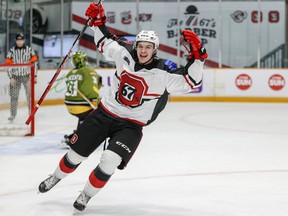 Ottawa 67’s forward Dylan Robinson celebrates after scoring the game-winning goal on a penalty shot against Battalion goalie Dom DiVincentiis yesterday.