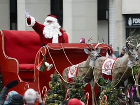Santa Claus waves at the crowd during a parade in Ottawa.