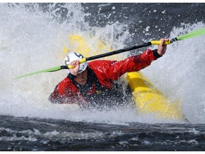 A kayaker paddles through the "Greyhound Buseater" wave on the Ottawa River's Rocher Fendu rapids.