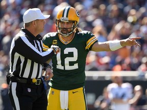 Aaron Rodgers of the Green Bay Packers talks with the referee during a game against the Chicago Bears at Soldier Field on Oct. 17, 2021 in Chicago.