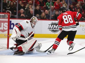 Patrick Kane #88 of the Chicago Blackhawks shoots past Matt Murray #30 of the Ottawa Senators to score a third period goal for a hat trick at the United Center on November 01, 2021 in Chicago, Illinois. The Blackhawks defeated the Senators 5-1 for their first win of the season.