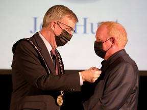 Mayor Jim Watson awards Jeff Hunt the Order of Ottawa at City Hall on Thursday.