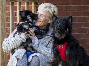 A very happy Christina Kennis with her dogs Chloe and pup Bella who recently returned from Cuba.
