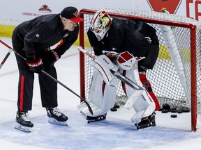 Senators goaltender Matt Murray talks with a member of the coaching staff.