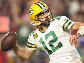 Quarterback Aaron Rodgers of the Green Bay Packers throws the football into stands after defeating the Arizona Cardinals 24-21 at State Farm Stadium on Oct. 28, 2021 in Glendale, Ariz.