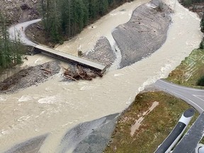 A swollen creek flows under a washed out bridge at the Carolin Mine interchange with Coquihalla Highway 5 after devastating rain storms caused flooding and landslides, near Hope, British Columbia, November 17, 2021.