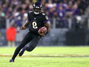 Ravens quarterback Lamar Jackson runs with the ball against the Browns at M&T Bank Stadium in Baltimore, Sunday, Nov. 28, 2021.