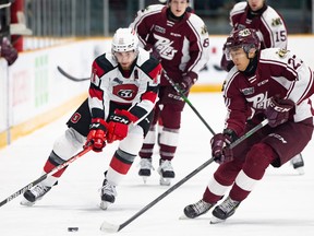 67’s Adam Varga (left) goes wide on the Petes’ James Guo at TD Place last night.