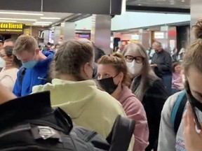 People gather to leave Hartsfield-Jackson Atlanta International Airport after reported shooting, in Atlanta, Georgia, U.S., November 20, 2021, in this still image obtained from a social media video.