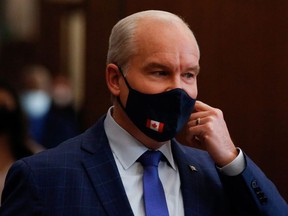 Canada's Conservative Party leader Erin O'Toole removes his mask as he speaks after the Throne Speech, outside the House of Commons, in Ottawa, Ontario, Canada November 23, 2021.