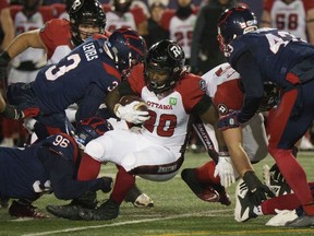 Ottawa Redblacks running back Timothy Flanders is tackled by Montreal Alouettes defensive back Patrick Levels during first quarter CFL football action in Montreal on Friday, November 19, 2021.