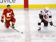 Flames winger Matthew Tkachuk, left, chats with his brother, Senators winger Brady Tkachuk, before a game in Calgary last season.