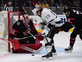 Senators defenceman Thomas Chabot (72) helps goaltender Filip Gustavsson defend the goal against Kings right-winger Alex Iafallo during the second period of Saturday's game.