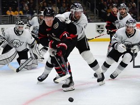 Ottawa Senators left wing Brady Tkachuk (7) plays for the puck against Los Angeles Kings defenceman Alexander Edler (2) and right wing Viktor Arvidsson (33) during the third period at Staples Center.