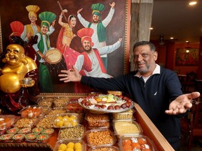Rangoli Indian Cuisine and Sweets owner Charanjit Singh poses for a photo at his store in Ottawa Thursday.