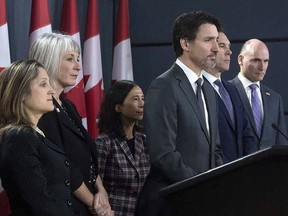 Prime Minister Justin Trudeau listens to a question with Deputy Prime Minister and Minister of Intergovernmental Affairs Chrystia Freeland, Minister of Health Patty Hajdu, Chief Medical Officer Theresa Tam, Minister of Finance Bill Morneau and President of the Treasury Board Jean-Yves Duclos during a news conference on the coronavirus situation in Ottawa on Wednesday, March 11, 2021.