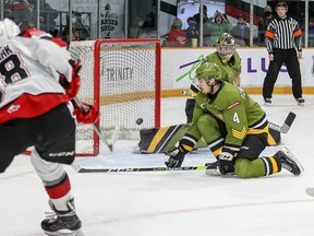 67's forward Vsevoled Gaidamak scores the game-winning goal past Paul Christopoulos (4) and goalie Joe Vrbetic of the Battalion in overtime.