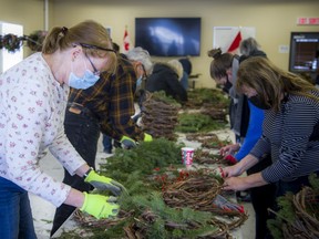 Volunteers gathered to help build wreaths at the Memorial Cross Building in Beechwood Cemetery, after the wreaths that were destined for the National Military Cemetery were stolen. Lorraine Alexan worked away assembling wreaths Saturday, Dec. 4, 2021.