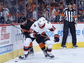 Keith Yandle of the Flyers and Connor Brown (28) of the Senators challenge for the puck during the third period of Saturday's game in Philadelphia.