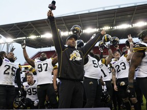 Hamilton Tiger-Cats head coach Orlondo Steinauer and his player celebrate winning the East with a win over the Toronto Argonauts during the Canadian Football League Eastern Conference Final game at BMO Field.