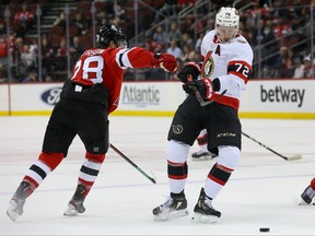 Senators defenceman Thomas Chabot (72) skates the puck past New Jersey Devils defenseman Damon Severson (28) during the first period at Prudential Center on Monday night.
