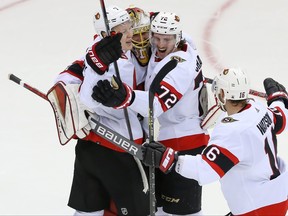 Senators goaltender Anton Forsberg (31) celebrates with Ottawa Senators defenceman Thomas Chabot (72), Ottawa Senators left wing Brady Tkachuk (7) and Austin Watson (16) after the shootout against New Jersey Devils at Prudential Center.