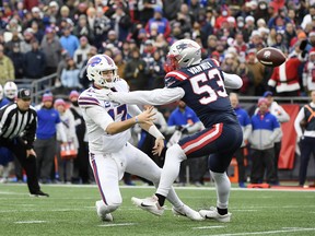 Buffalo Bills quarterback Josh Allen sidearms a pass around New England Patriots linebacker Kyle Van Noy at Gillette Stadium.