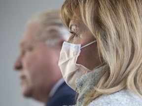 Ontario Health Minister Christine Elliott stands alongside Premier Doug Ford as he takes a question from the media following an announcement at Mississauga Hospital in Mississauga on Wednesday, Dec. 1, 2021.
