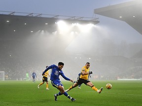 Reece James of Chelsea crosses under pressure during the Premier League match between Wolverhampton Wanderers and Chelsea at Molineux on Dec. 19, 2021 in Wolverhampton, England.
