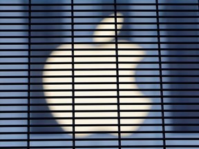The Apple logo is seen through a security fence erected around the Apple Fifth Avenue store as votes continue to be counted following the 2020 U.S. presidential election, in Manhattan, New York City, U.S., November 5, 2020.