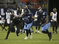 Hamilton Tiger Cats, Steven Dunbar Jr. WR (82) is about to be tackled by Toronto Argos Henoc Muamba LB (10) and teammate Crezdon Butler DB (24) during the Nov. 12 matchup in Toronto. The Argos won that one to clinch top spot in the CFL East Division standings.