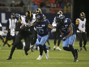 Hamilton Tiger Cats, Steven Dunbar Jr. WR (82) is about to be tackled by Toronto Argos Henoc Muamba LB (10) and teammate Crezdon Butler DB (24) during the Nov. 12 matchup in Toronto. The Argos won that one to clinch top spot in the CFL East Division standings.