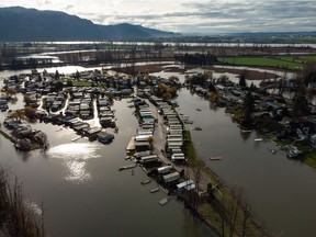 Properties on Hatzic Lake are surrounded by high water after floodwaters began to recede, near Mission, B.C., on Sunday, Dec. 5, 2021.