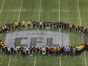 Tiger-Cats team members gather at mid-field during practice on Friday.