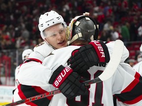 Senators captain Brady Tkachuk delivers a bear hug to goalie Anton Forsberg, who played a starring role in Thursday's road victory against the Carolina Hurricanes.