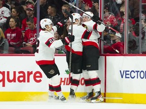 Ottawa Senators center Josh Norris (9) celebrates his goal against the Carolina Hurricanes with right wing Drake Batherson (19) and defenceman Nikita Zaitsev (22) during the third period at PNC Arena.