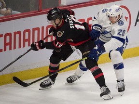 Ottawa Senators left wing Tim Stuetzle (18) and Tampa Bay Lightning center Riley Nash (20) battle in the third period at the Canadian Tire Centre.