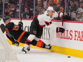 Flyers defenceman Justin Braun (61) and Senators winger Brady Tkachuk collide while battling for the puck in the second period of Saturday's game at Philadelphia.