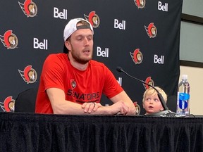 While his son, Ben, looks on, Senators goaltender Anton Forsberg speaks to the media following his team's 4-0 victory against the Lightning on Saturday. The shutout was the first in the National Hockey League for Forsberg.