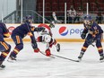 Ottawa's Brady Stonehouse gets upended by Barrie's Grayson Tiller as Beau Jelsma (53) looks on.