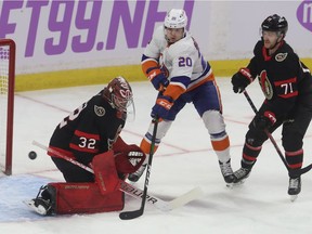 Ottawa Senators goalie Filip Gustavsson makes a save against Islander Kzieffer Bellows on Tuesday night.